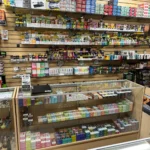 Display of disposable vapes, Geek Bar, shisha, cigarillos, and cigarettes at Fox Plaza Smoke Shop.