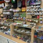 Stash cans, grinders, scales, and smoking accessories displayed at Fox Plaza Smoke Shop in El Paso.