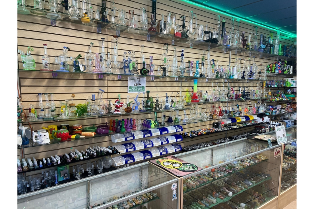 Water pipes, bongs, and bubblers in the glass case at Mesa Smoke Shop on N Mesa St