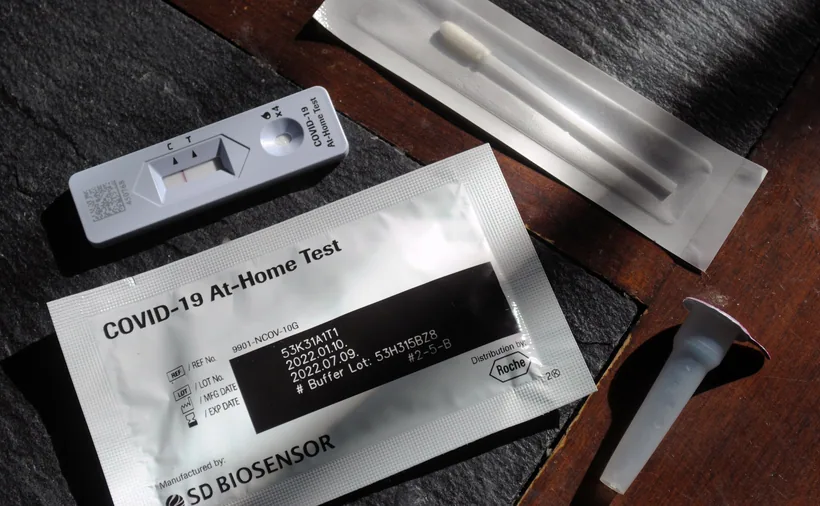An at-home test kit laid out with a result cassette showing the C and T window, a collection swab, buffer tube, and instruction packaging at El Paso Smoke Shops