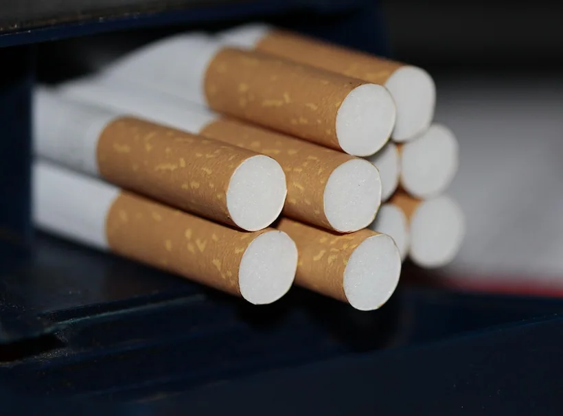 Rows of finished filtered cigarette tubes showing cork filter ends and tube length at El Paso Smoke Shops