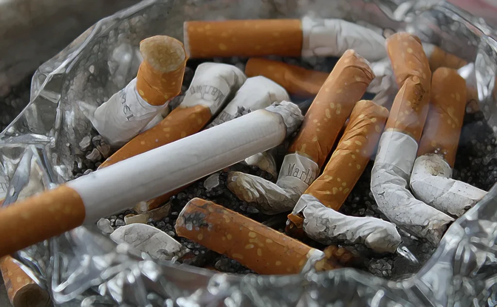 Close-up of filtered cigarettes in an open box showing the tan filter tips and white paper tubes at El Paso Smoke Shops