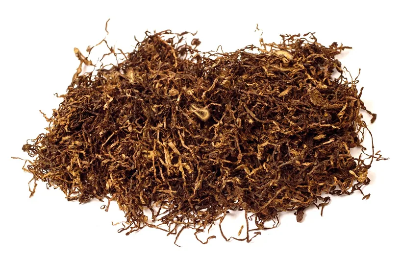 A pile of loose finely-cut roll-your-own shag tobacco on a white background at El Paso Smoke Shops