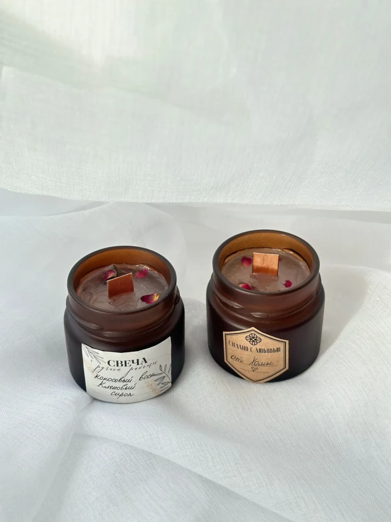 Amber glass scented jar candle with a printed label resting in a wooden bowl with botanicals at El Paso Smoke Shops