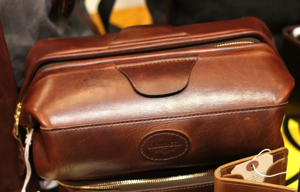Premium brown leather dopp kit with brass zipper and grab handle at El Paso Smoke Shops