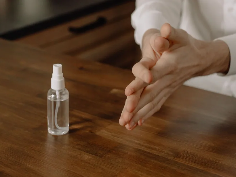 A clear pump-spray cleaner bottle of liquid solution set out on a table, ready for a quick pour-and-shake clean, at El Paso Smoke Shops