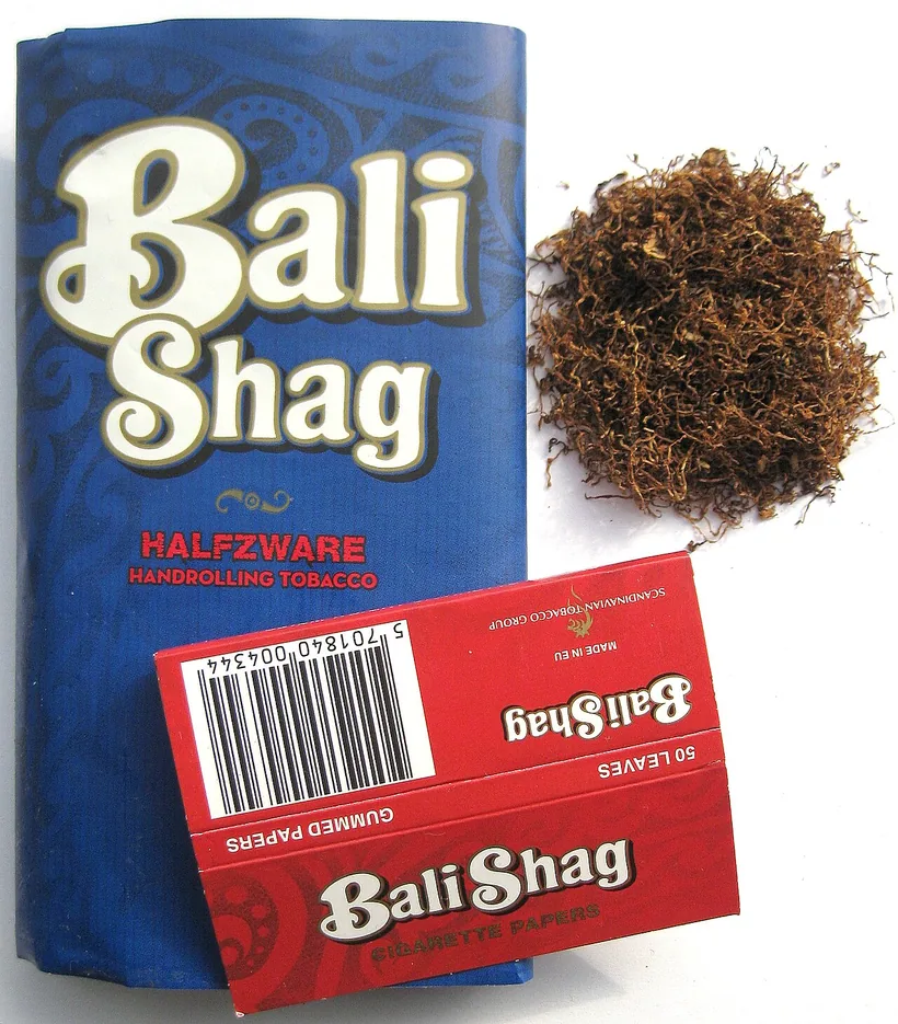 A pouch of handrolling tobacco, a pack of cigarette papers, and a measured pile of loose brown tobacco at El Paso Smoke Shops