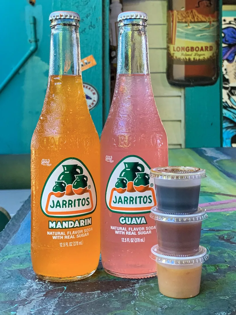 Two glass bottles of natural-flavor fruit soda made with real sugar at El Paso Smoke Shops