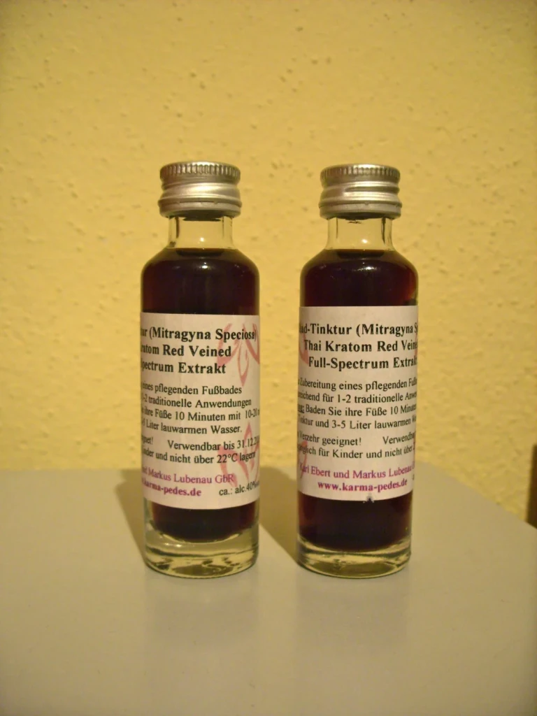 Two small bottles of liquid full-spectrum kratom extract tincture with Mitragyna speciosa red-vein labels at El Paso Smoke Shops
