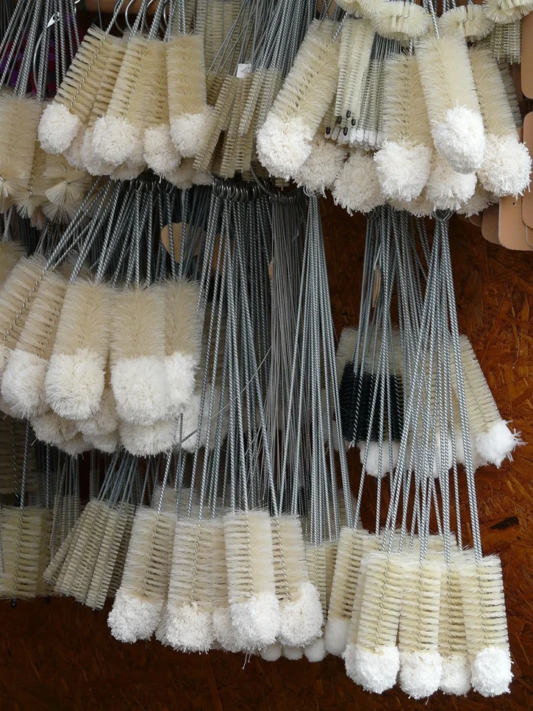 A wall of bristled bottle brushes used for cleaning the inside of glass vessels at El Paso Smoke Shops
