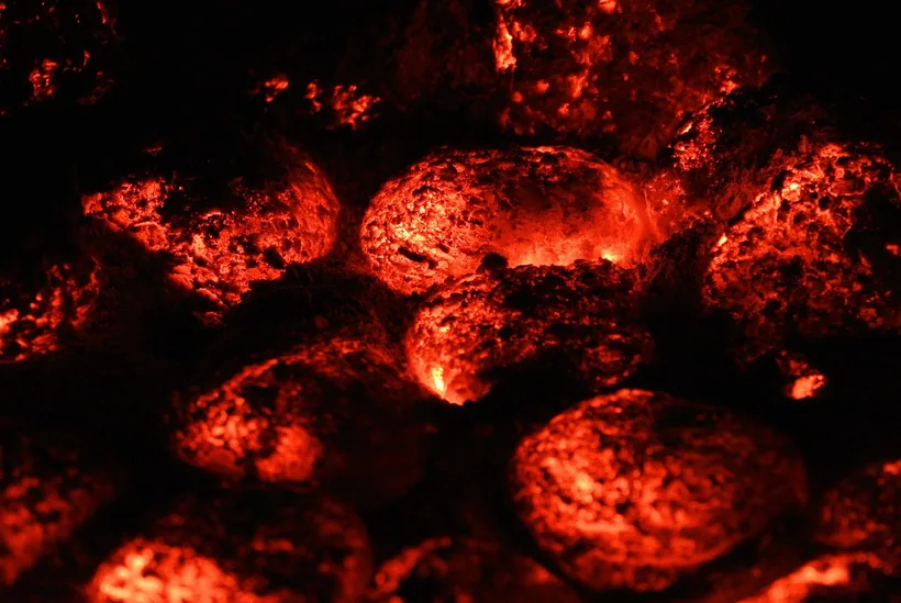 Charcoal cubes glowing fully red-hot, indicating they are completely lit and ready for the hookah bowl at El Paso Smoke Shops