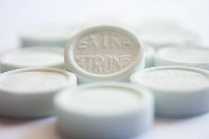 A cluster of round pressed mint lozenge tablets, representing the range of Nic Nac lozenge strengths and flavors at El Paso Smoke Shops