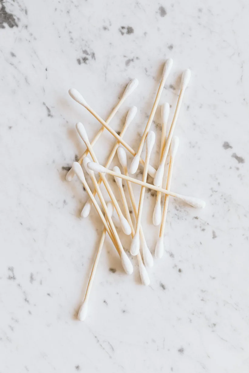Bamboo cotton swabs laid out on marble, the slim cotton tool fed through a pipe stem or downstem to clean it at El Paso Smoke Shops