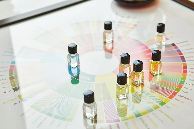 Small dropper-cap reagent bottles arranged on a printed color comparison chart at El Paso Smoke Shops