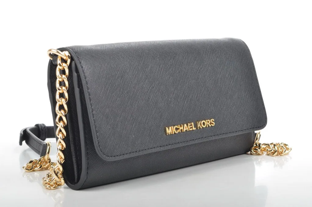 Black leather crossbody bag with a gold chain strap photographed on a white background at El Paso Smoke Shops