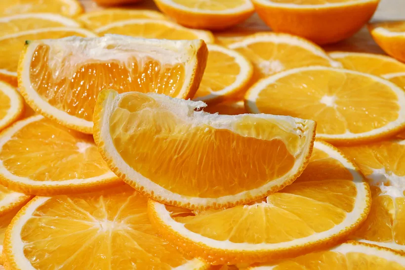 Fresh juicy orange slices and wedges representing citrus-forward odor sprays at El Paso Smoke Shops