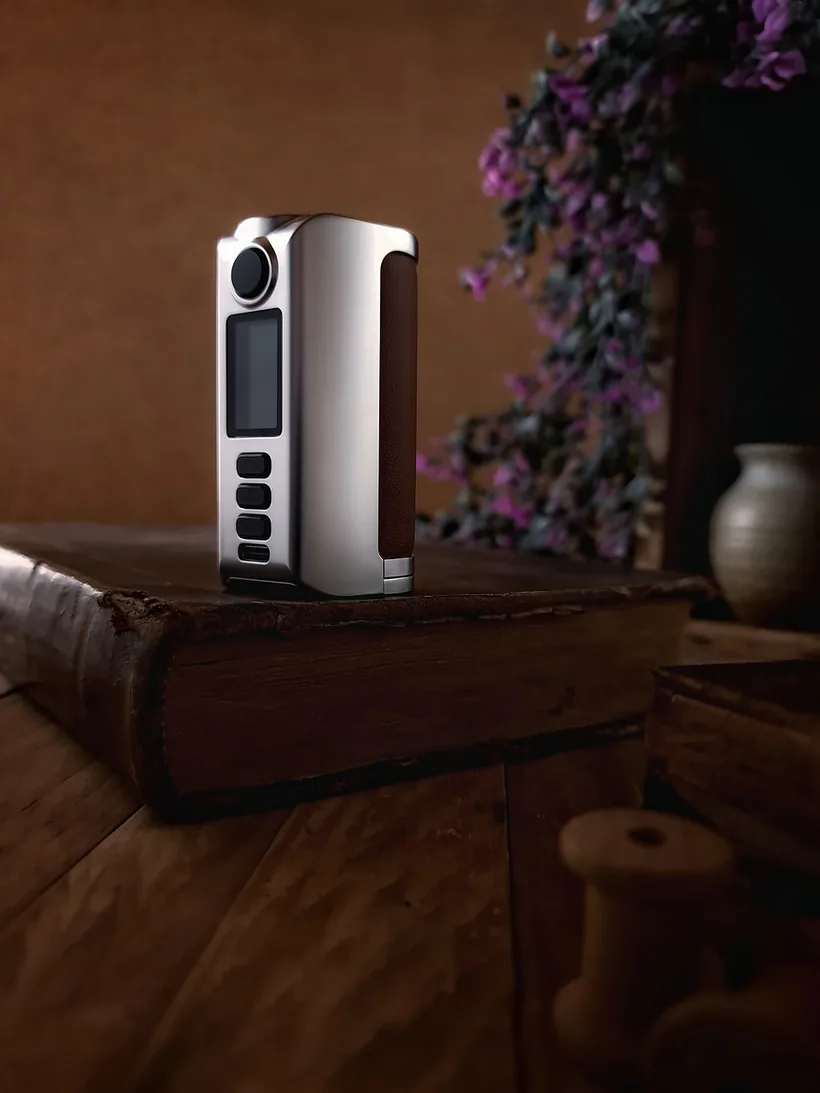 Premium vape mod device with a digital wattage display on a wooden surface at El Paso Smoke Shops