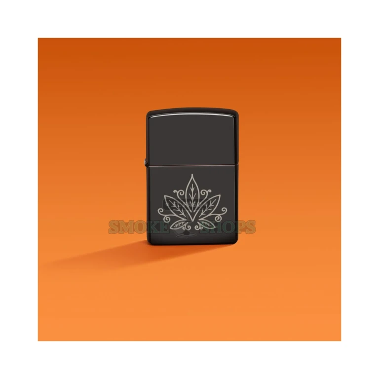 Open Zippo windproof lighter in High Polish Black with the flame lit and the zentangle cannabis leaf engraving visible