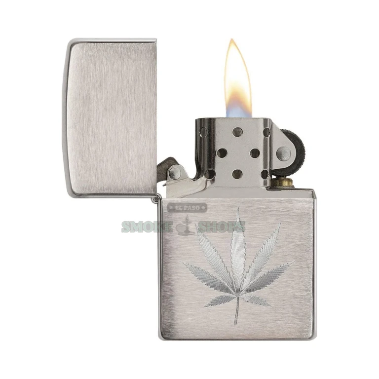Brushed chrome Zippo lighter showing the matte low-glare finish and auto-engraved cannabis leaf detail