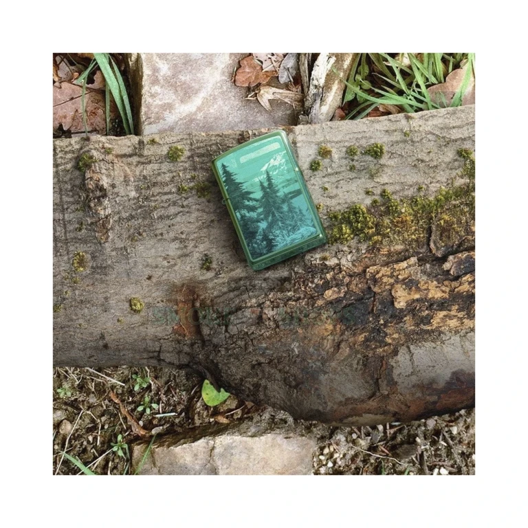 Zippo Mountain Design windproof lighter in High Polish Teal, model 49461, closed front view showing a mountainside framed by pine trees