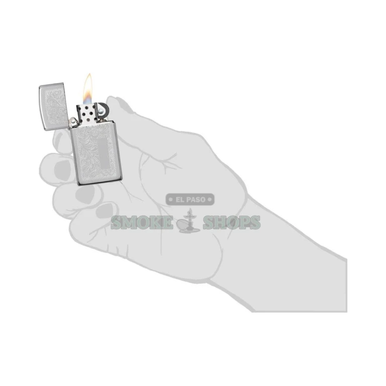 Zippo Slim Venetian high polish chrome windproof lighter model 1652, closed, showing the engraved floral and scroll pattern
