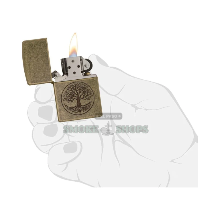 Zippo Tree of Life Antique Brass lighter shown at an angle to highlight the worn brass finish and hinge