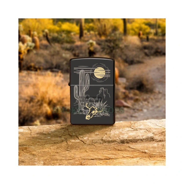 Closed Zippo 48968 High Polish Black case showing the laser-etched Western landscape with brass tones revealed beneath the glossy black finish