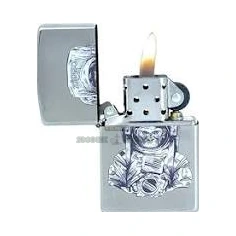 Close-up of the Space Chimp Zippo lighter in El Paso, suited chimp and helmet artwork on the satin chrome flip-top case