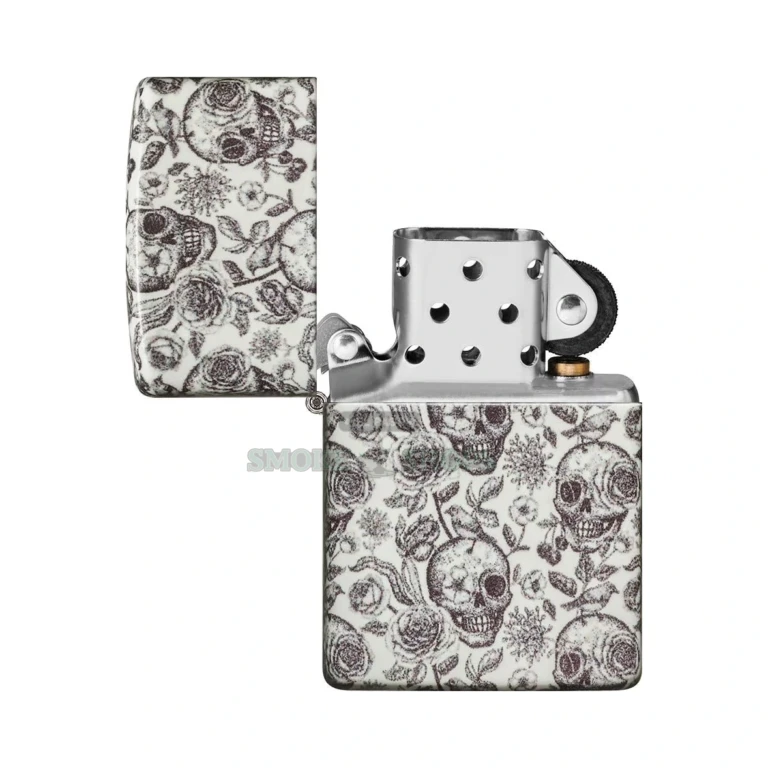 Zippo Skeleton 49458 glowing greenish in the dark after charging under light, skull-and-rose pattern visible