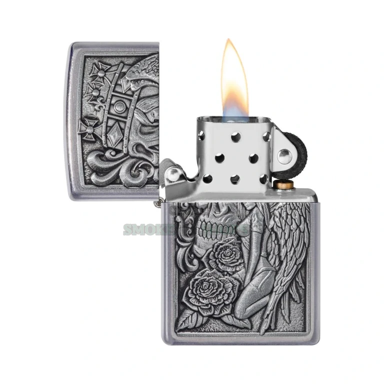 Close-up of the Zippo 49442 skull and angel emblem showing the crown, roses, and filigree detail on the Street Chrome case